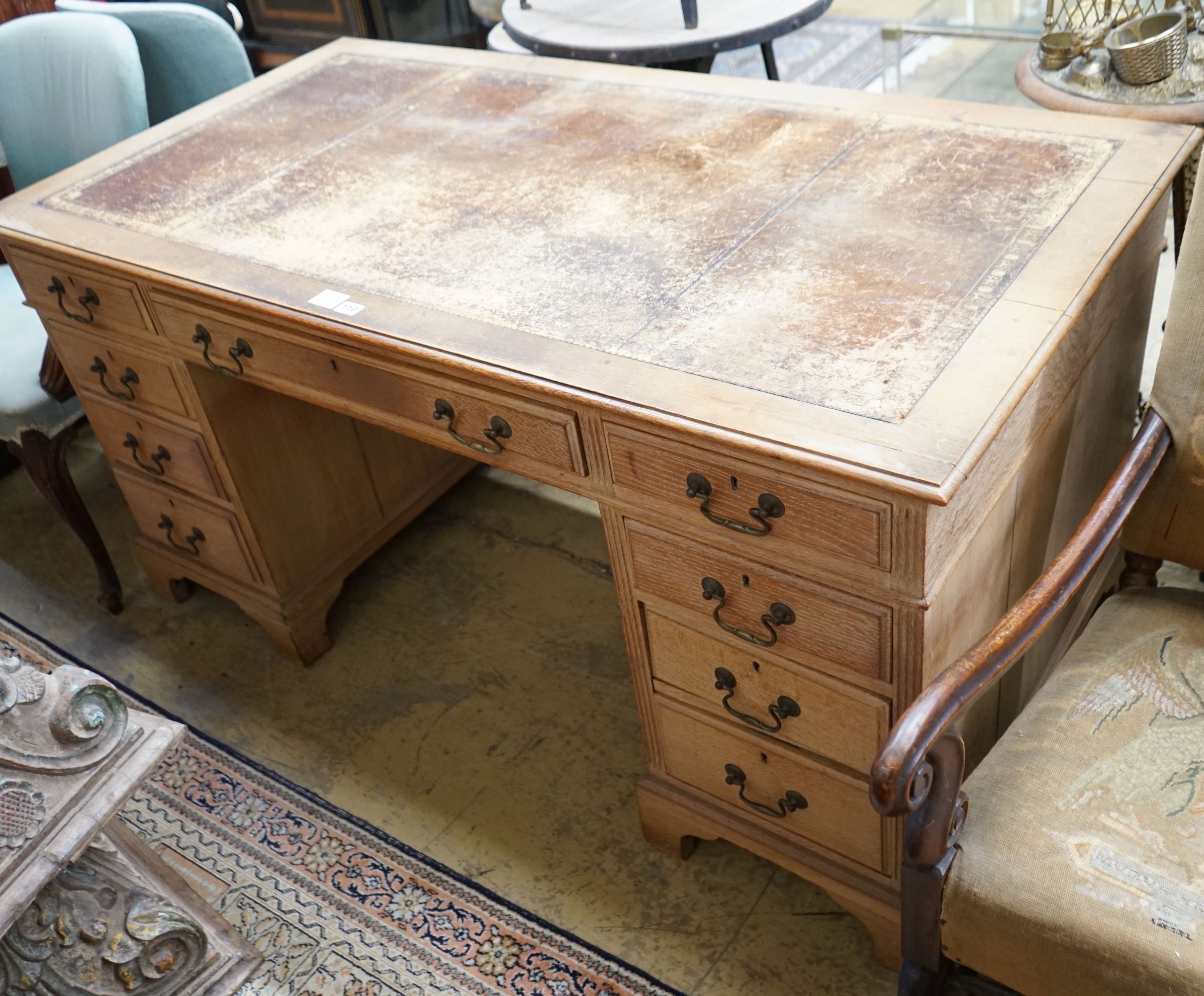 An early 20th century faded oak pedestal desk, length 153cm, depth 80cm, height 77cm